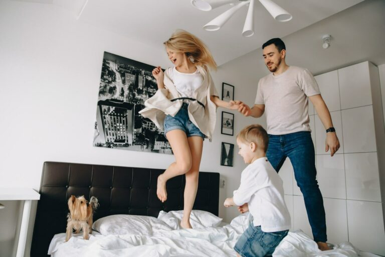 Family jumping on bed